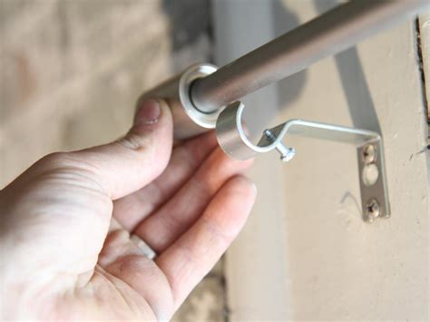 installing curtain brackets and hitting metal|installing window curtain rods.